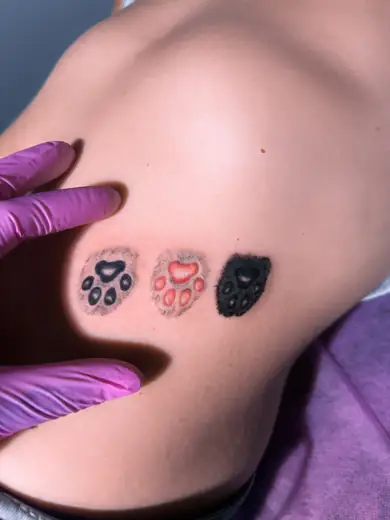 Small paw print tattoo by Kristina Vishar